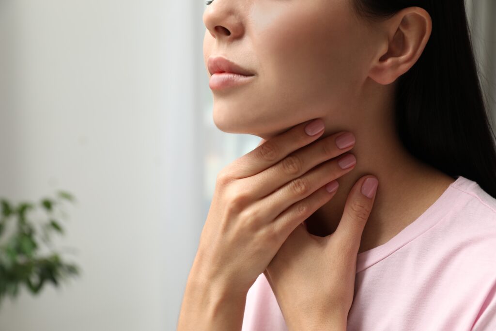 Photo of woman holding onto her neck