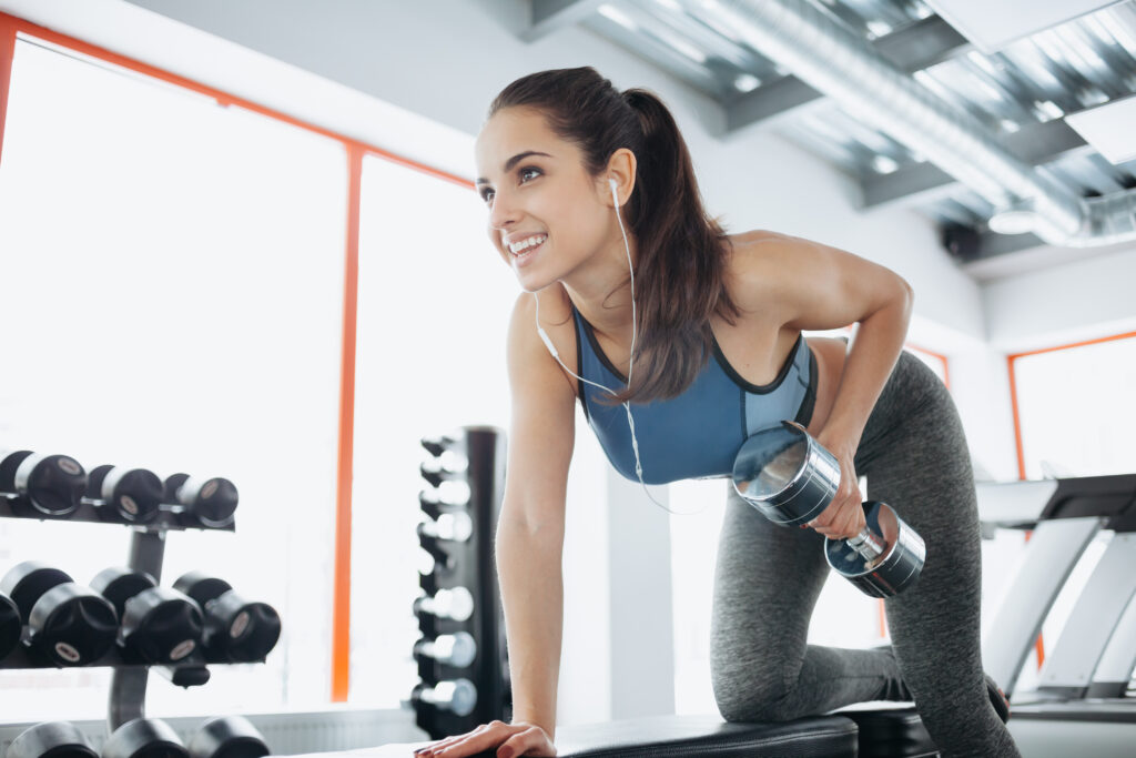 Photo of woman weight training in the gym