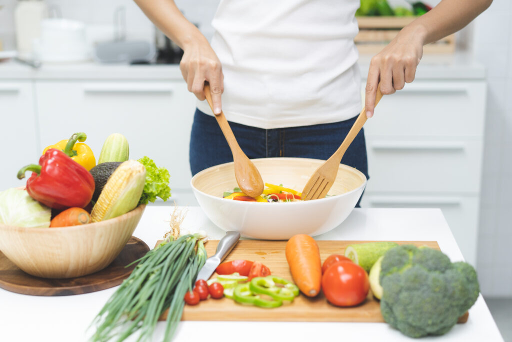 Photo of woman in kitchen making healthy food